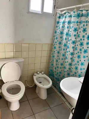 a bathroom with a toilet and a sink at Cabañas La Juana in San Luis