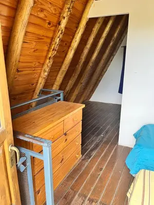 a room with a bed and a wooden ceiling at Cabañas La Juana in San Luis