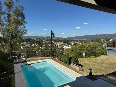 a swimming pool on top of a house at Villa Socrates in Villa Carlos Paz