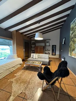 a living room with a couch and a table at Villa Socrates in Villa Carlos Paz