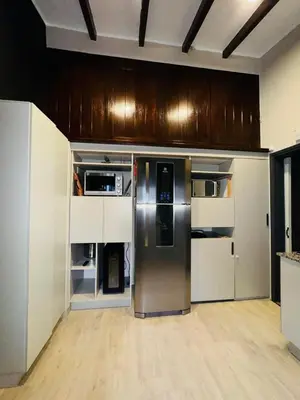 a kitchen with a stainless steel refrigerator and cabinets at Villa Socrates in Villa Carlos Paz