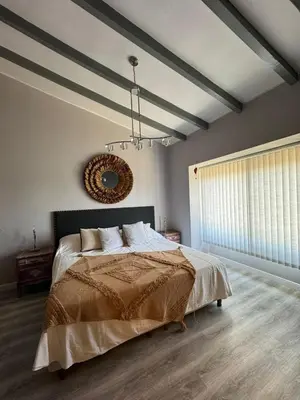 a bedroom with a bed and a mirror on the wall at Villa Socrates in Villa Carlos Paz