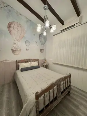 a bedroom with a bed and a wall with balloons at Villa Socrates in Villa Carlos Paz