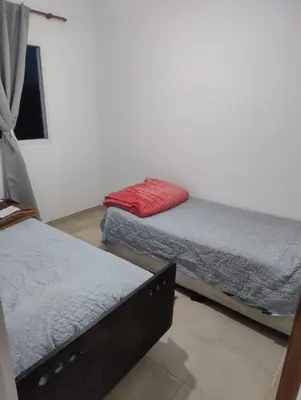 a room with two beds and a red pillow at Rincon de Olivares in Los Olivares