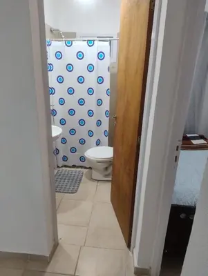 a bathroom with a toilet and a shower curtain at Rincon de Olivares in Los Olivares