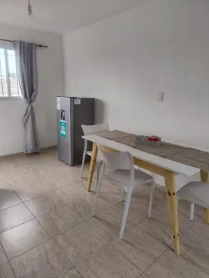a table and chairs in a room with a refrigerator at Rincon de Olivares in Los Olivares