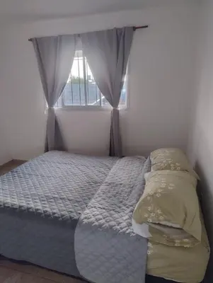 a small bedroom with a bed with a window at Rincon de Olivares in Los Olivares