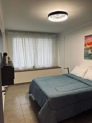 a bedroom with a large bed and a window at Departamento luminoso y acogedor en Alberdi in Cordoba
