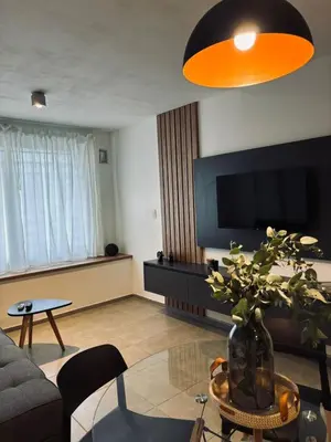 a living room with a couch and a vase with a plant at Departamento luminoso y acogedor en Alberdi in Cordoba