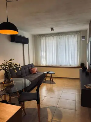 a living room with a couch and a table at Departamento luminoso y acogedor en Alberdi in Cordoba
