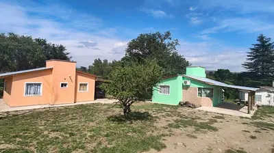 a house with a tree in front of it at Cabaña Cecilia II in Villa Icho Cruz