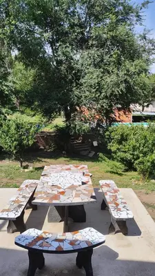 a group of picnic tables with tiles on them at Cabaña Cecilia II in Villa Icho Cruz