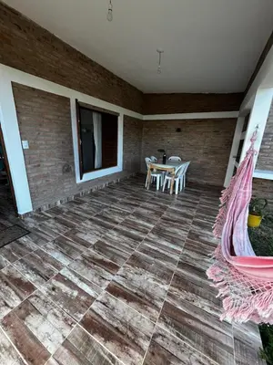 a patio with a table and chairs on a brick wall at Cabañas Refugio del Alma in Villa Amancay