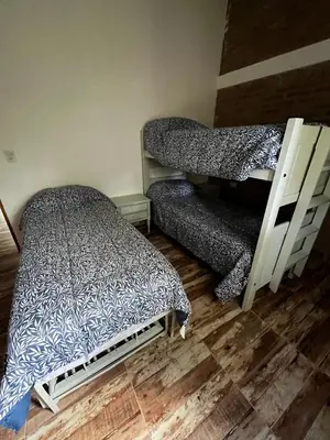 a bedroom with two bunk beds and a bed at Cabañas Refugio del Alma in Villa Amancay