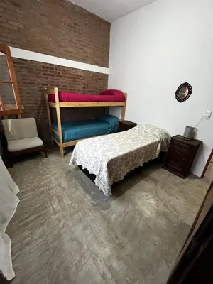a bedroom with a bed and a chair at Cabañas Refugio del Alma in Villa Amancay