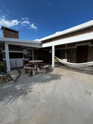 a building with a picnic table in the courtyard at Cabañas Refugio del Alma in Villa Amancay