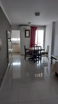 a dining room with a table and chairs on a tile floor at Departamento en Cordoba, Torre Nubis in Cordoba