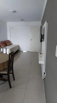a white room with a room with a bed and a table at Departamento en Cordoba, Torre Nubis in Cordoba