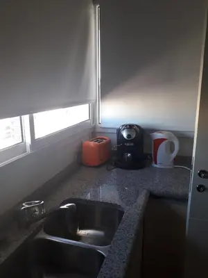 a kitchen counter with a sink and a microwave at Departamento en Cordoba, Torre Nubis in Cordoba