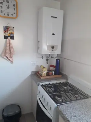 a kitchen with a stove and a white cabinet at Departamento en Cordoba, Torre Nubis in Cordoba