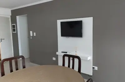 a dining room with a table and a tv on a wall at Departamento en Cordoba, Torre Nubis in Cordoba