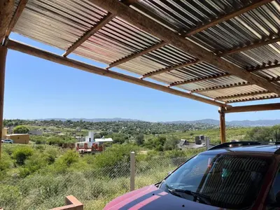 a car parked under a pergola with a view at La casita de Nestor in Cavalango