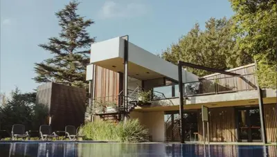 a house with a balcony and a swimming pool at La urumpta hotel aken mind in Río Cuarto