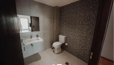 a bathroom with a toilet and a sink at La urumpta hotel aken mind in Río Cuarto