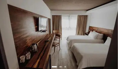 a hotel room with two beds and a desk at La urumpta hotel aken mind in Río Cuarto