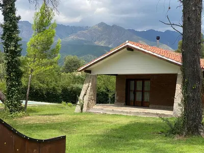 a small house with a view of a mountain at Casa de Campo in Los Hornillos
