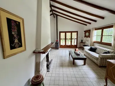 a living room with a couch and a fireplace at Casa de Campo in Los Hornillos