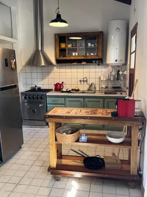 a kitchen with green cabinets and a counter in it at Casa de Campo in Los Hornillos
