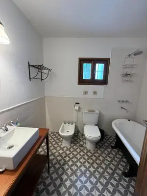 a bathroom with a sink and a toilet and a tub at Casa de Campo in Los Hornillos