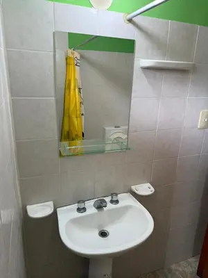 a bathroom with a sink and a mirror at Complejo El Trencito in Villa Cura Brochero