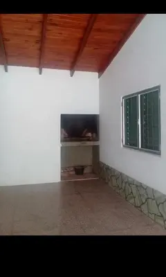 a white room with a fireplace and a window at Complejo El Trencito in Villa Cura Brochero