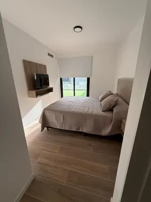 a bedroom with a bed and a tv on the wall at depto carlos paz in Villa Carlos Paz