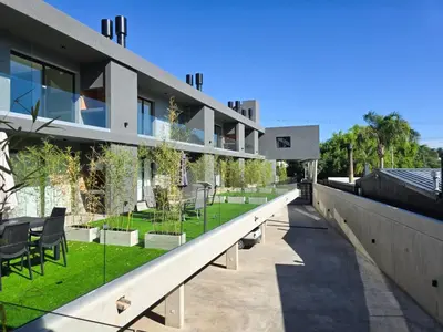 an external view of a building with chairs and plants at depto carlos paz in Villa Carlos Paz