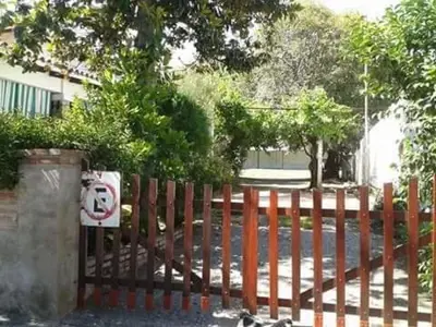 a fence with a sign on it next to a street at 