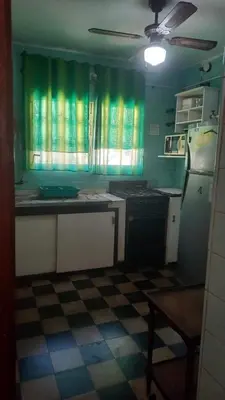 a kitchen with green walls and a checkered floor at 