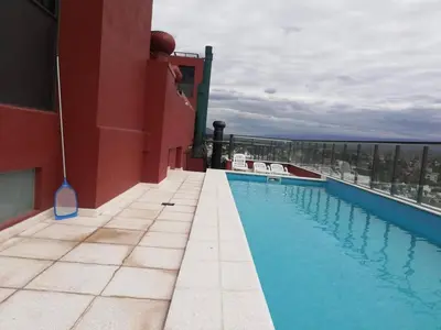 a swimming pool on the roof of a building at Departamento Edificio Leonardo 1 in Villa Carlos Paz