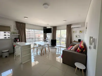 a living room with a couch and a table at Departamento Edificio Leonardo 1 in Villa Carlos Paz