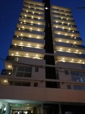 a tall building with lights on it at night at Departamento Edificio Leonardo 1 in Villa Carlos Paz