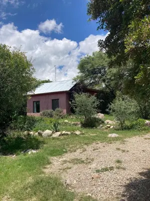 a red building with a metal roof in a yard at CasaMonte in San Javier