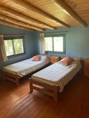 two beds in a room with wooden floors and windows at CasaMonte in San Javier