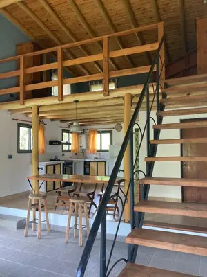 a wooden staircase in a room with a table and chairs at CasaMonte in San Javier