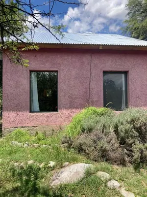 a pink house with two windows in a yard at CasaMonte in San Javier
