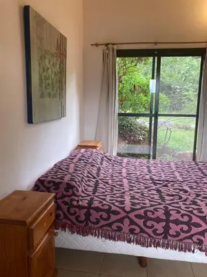 a bedroom with a purple bed with a window at CasaMonte in San Javier