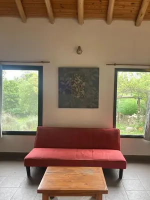 a red couch in a room with two windows at CasaMonte in San Javier