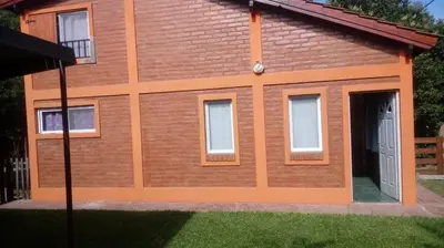 a red brick house with a door and windows at Doña Elba in Merlo