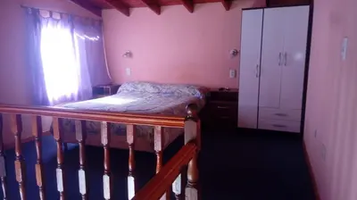 a small bedroom with a bed and a window at Doña Elba in Merlo